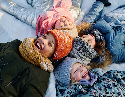 Image Children lying on snow and laughing